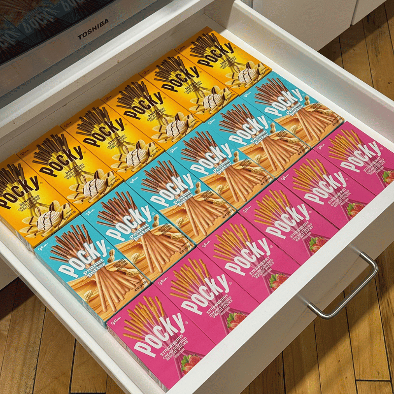 Pocky boxes in Banana, Peanut Butter, and Strawberry flavors arranged in a drawer.