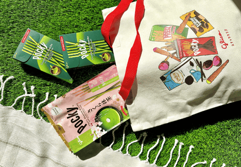 Pocky Double Rich Matcha and Cherry Blossom Matcha coming out from the tote bag