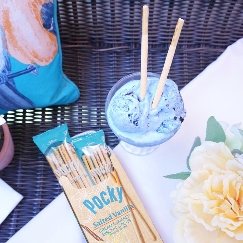 A package of Pocky Salted Vanilla lies with a glass of chocolate mint ice cream with two Pocky Salted Vanilla sticks inserted.