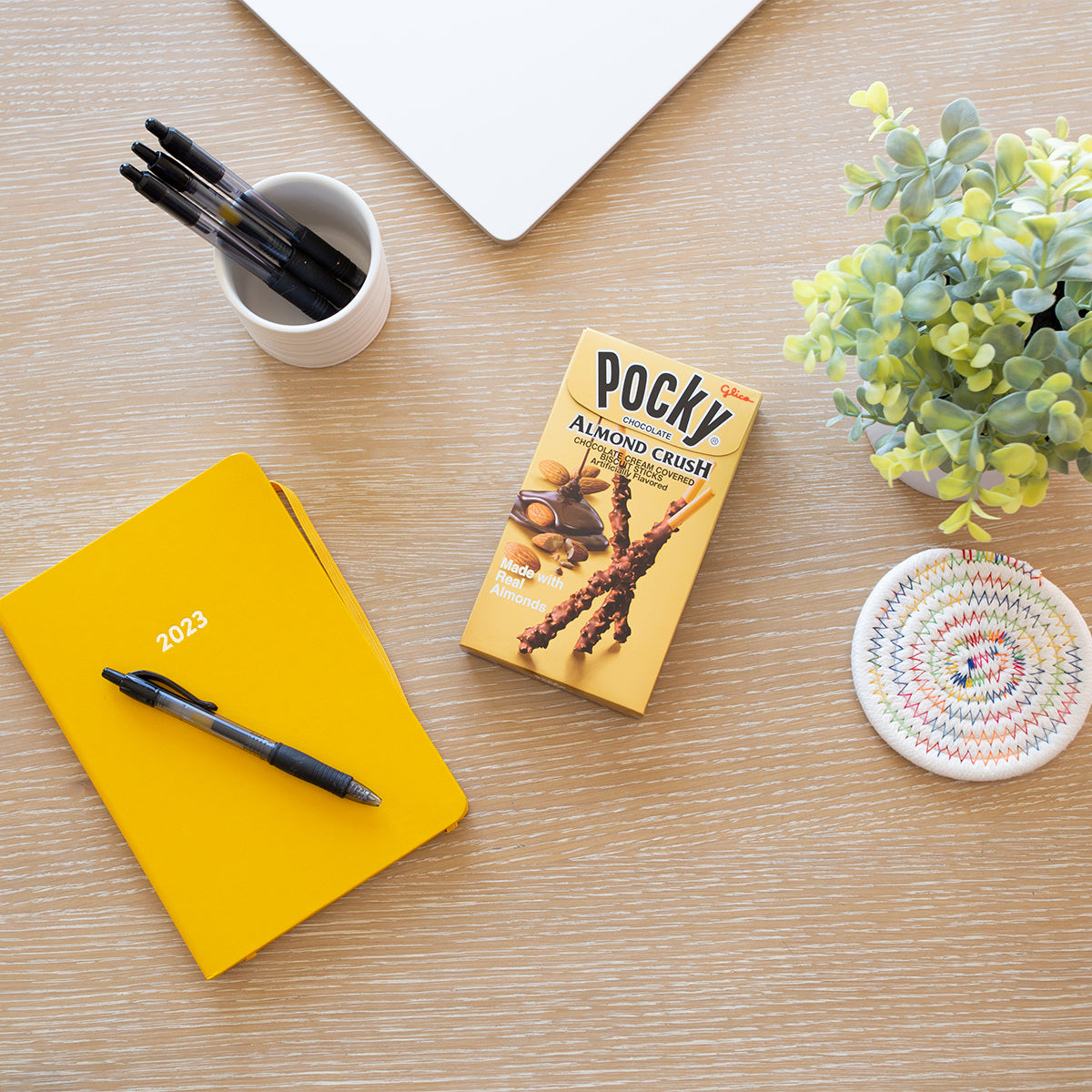 Pocky Almond Crush on table with pens and notebook