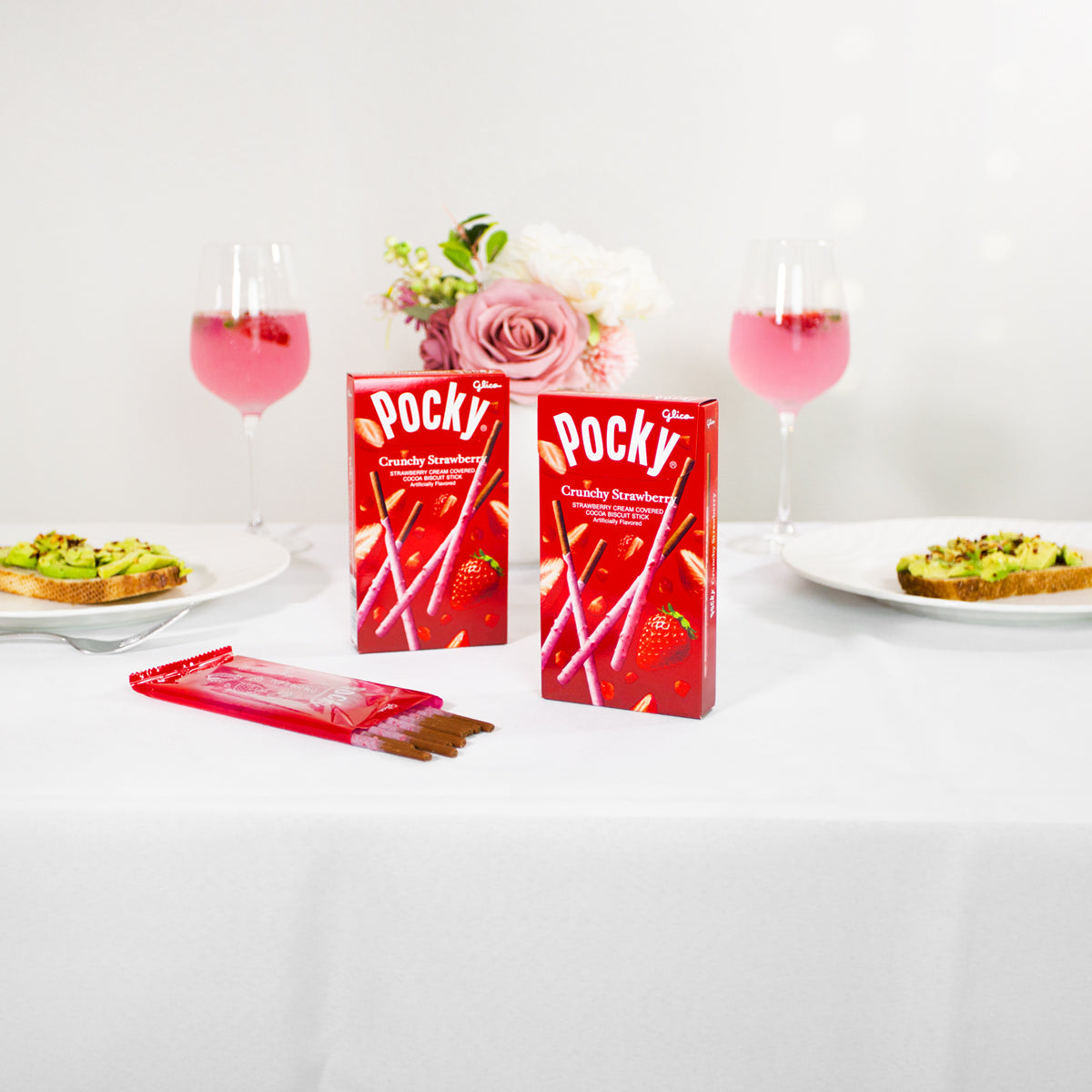 Pocky Strawberry on table with avocado toast and champagne