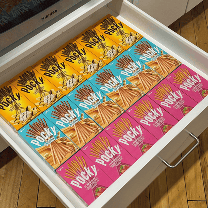 Pocky boxes in Banana, Peanut Butter, and Strawberry flavors arranged in a drawer.